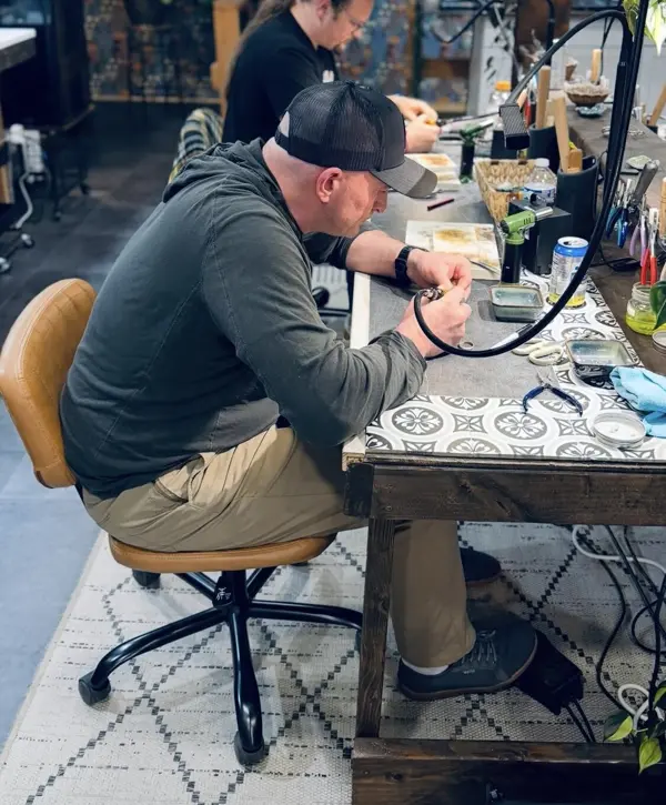 A student working at his own bench in the studio